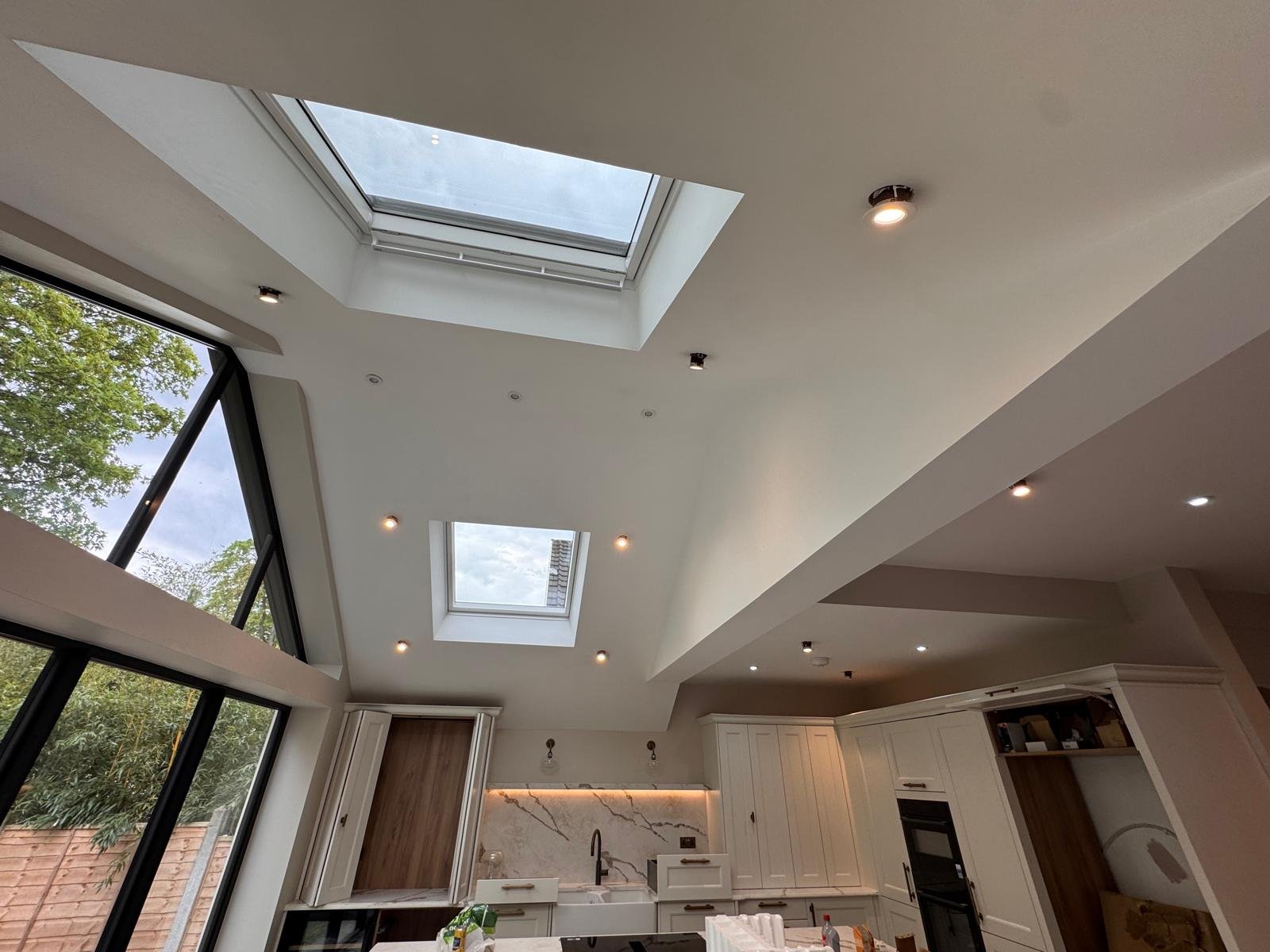 Kitchen extension with two roof lanterns and angled glazing