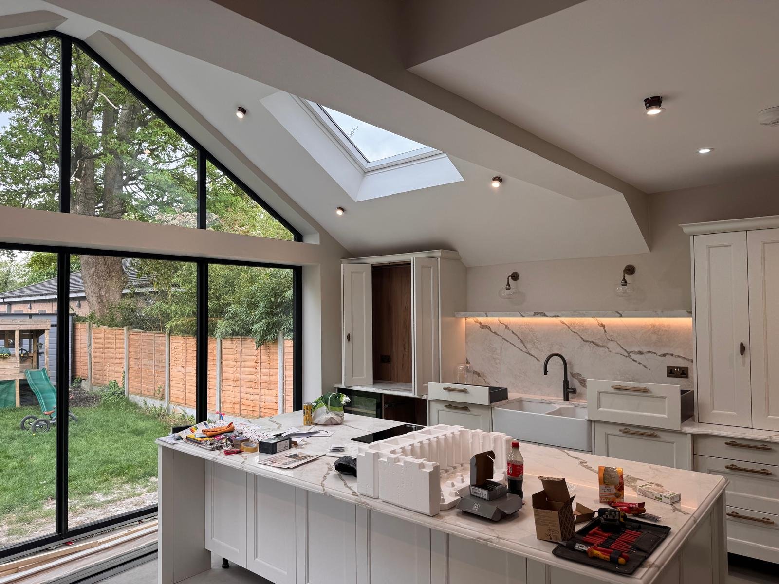 Kitchen extension with an island, roof lantern and full height glazing