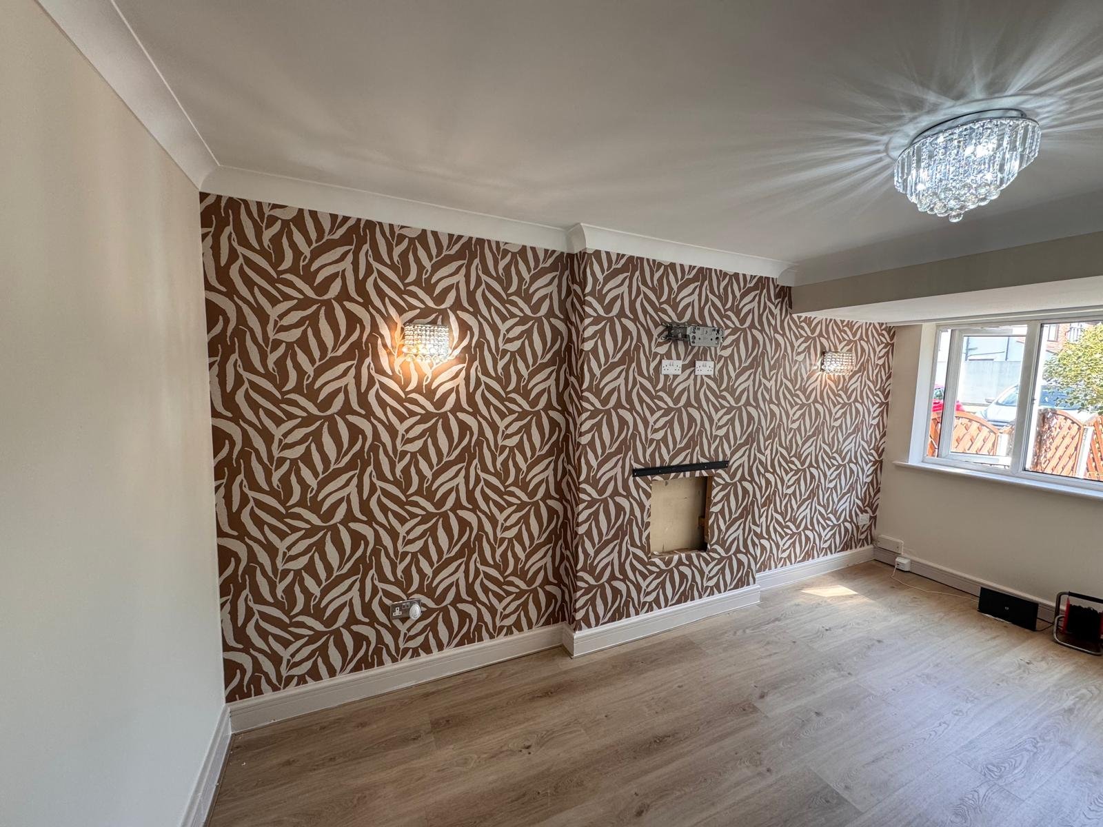 Living room with a patterned feature wall either side of a fireplace