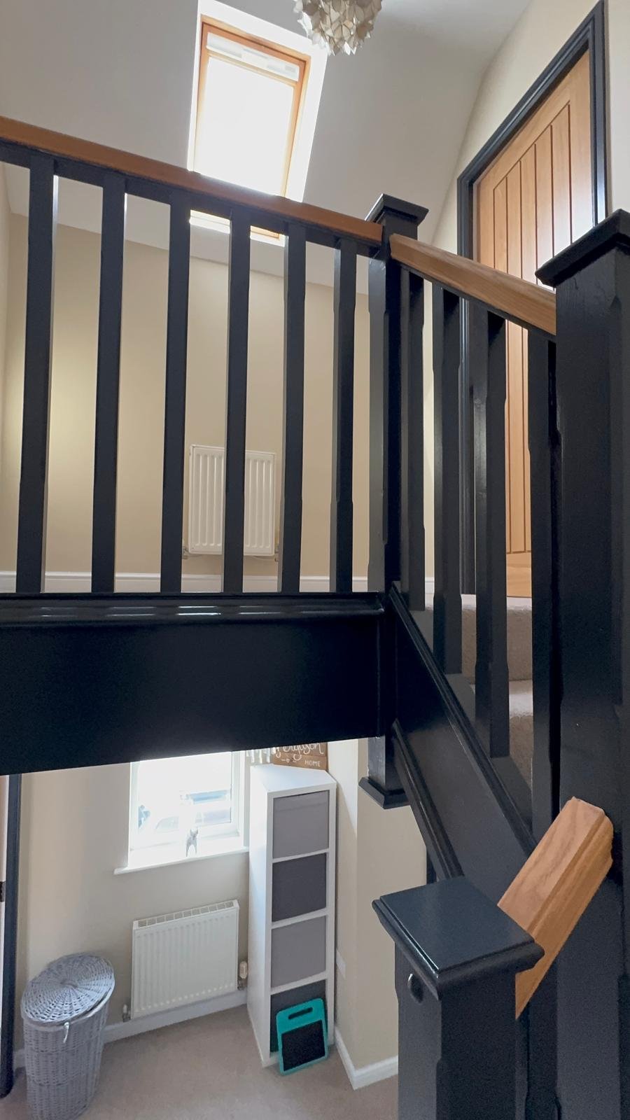 Staircase with black spindles and a timber handrail